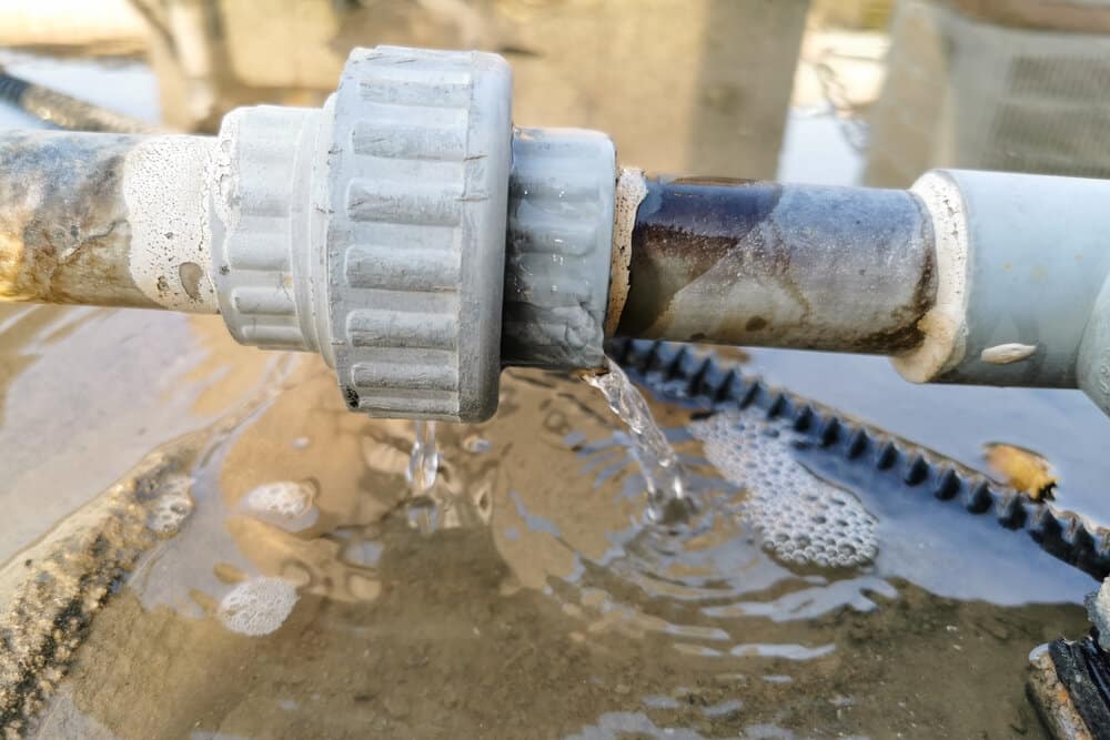 humid leaking pipe of a central air conditioning system and cold water drops on it