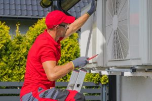 Professional AC Technician Performing Regular Maintenance Check of Residential Air Conditioning External Unit.