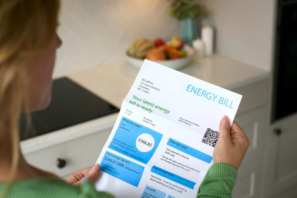 Close Up Of Woman Opening Energy Bill