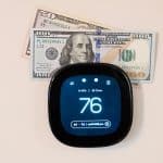 Money on top of digital smart thermostat