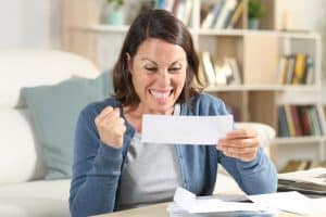 Excited adult woman celebrating a rebate check