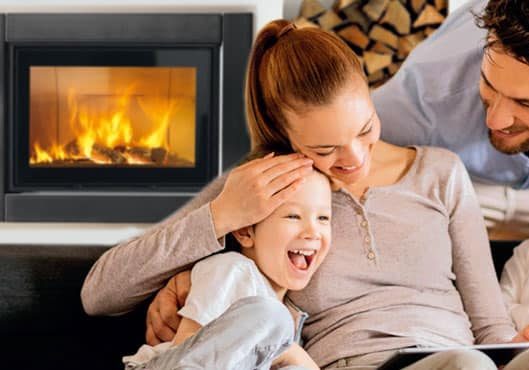 Family Sitting By A Gas Fireplace