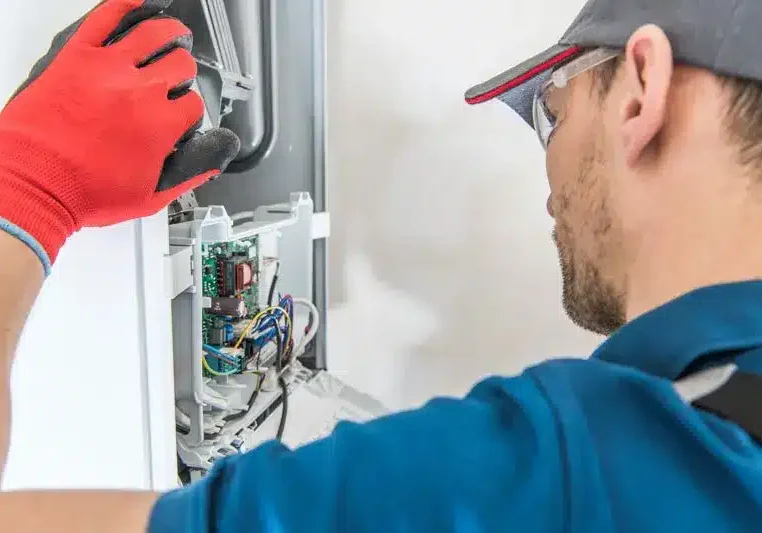 Gas Furnace Technician Working On Furnace