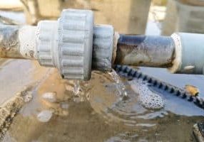 humid leaking pipe of a central air conditioning system and cold water drops on it