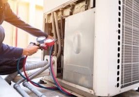 Technician is checking air conditioner ,measuring equipment for filling air conditioners.
