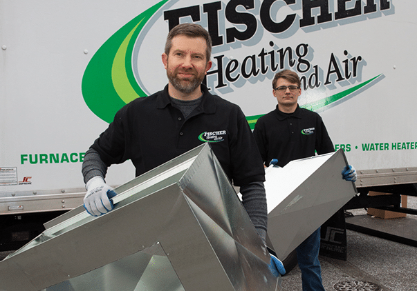 Fischer Heating &Amp; Air Conditioning Technicians Carrying Hvac Supplies