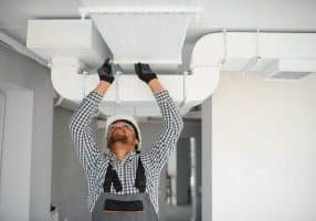 hvac services worker install ducted pipe system for ventilation and air conditioning in house.