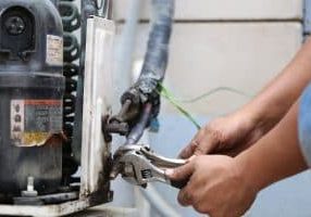 Close up of repairman on the fixing HVAC system
