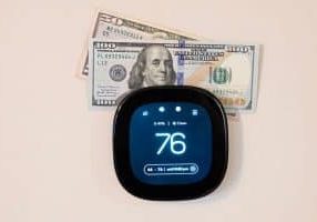 Money on top of digital smart thermostat