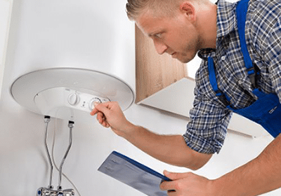 Technician Checking A Water Heater Control System